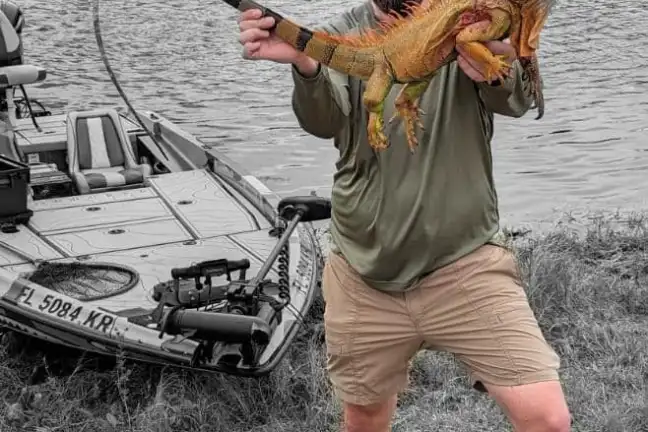 a man that is standing in the grass