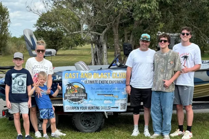 a group of people standing in the grass