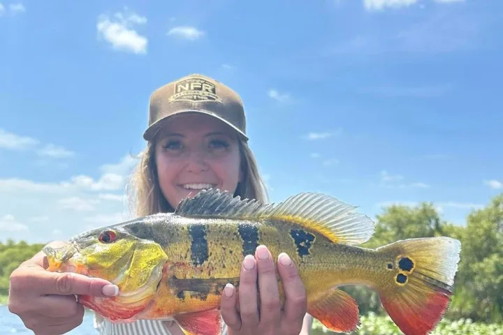 a person holding a fish in the water
